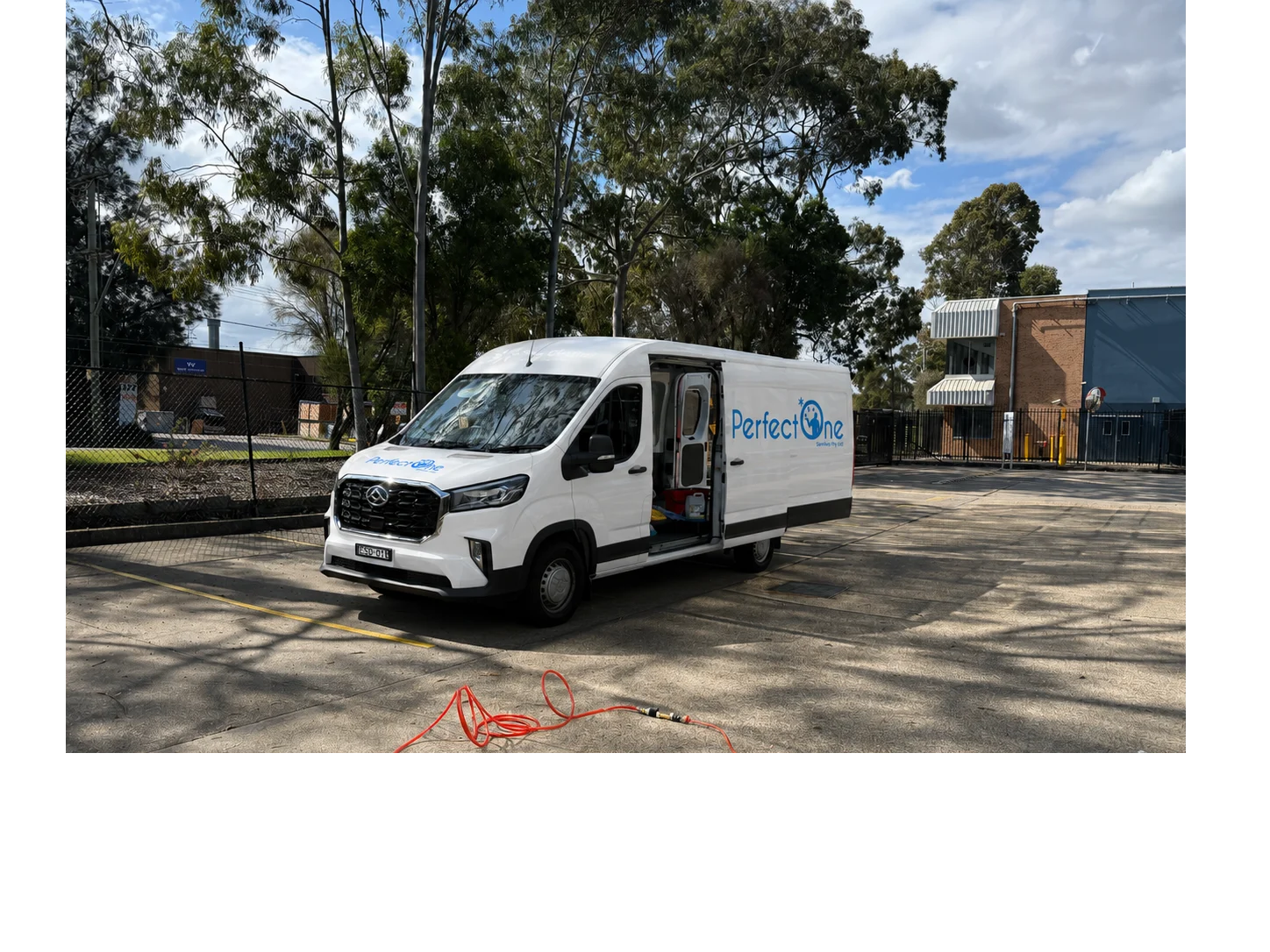Perfect One Services branded van at a commercial cleaning site